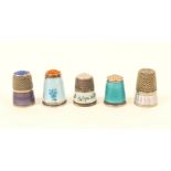 Five enamel decorated thimbles, comprising; a blue floral example with hardstone top, stamped to the