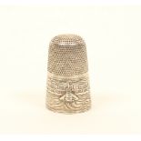 A rare 19th century English pictorial silver thimble, depicting a bridge with a buoy or tower with