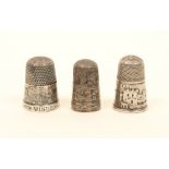 Three 19th century English silver pictorial thimbles, comprising Windsor Castle (x2) and Brighton