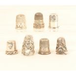 Seven silver and white metal thimbles, comprising; a Cable style example, a Charles Horner