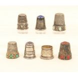 Seven silver and white metal thimbles, comprising; an example stamped "800" with 'turquoise'