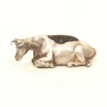 A 19th century silver pincushion in the form of a recumbent cow, lightly engraved coat, blue