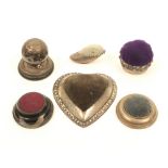 Six silver or silver mounted table pincushions, comprising; a heart shaped example, Birmingham,