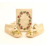 A pair of 19th century floral embroidered silk shoes for a baby, and a notebook in silk covers,