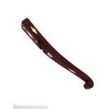 A 19th century mahogany knitting stick of curved form, with scroll end inlaid with bone diamond