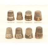 Nine silver thimbles, mostly American, all with decorative borders, including one with pierced