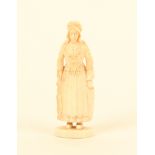 A good Dieppe carved ivory standing needlecase in the form of a fisherwoman, in traditional costume,