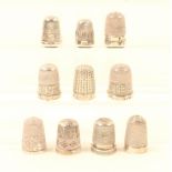 Ten English silver thimbles, most with decorative borders, all hallmarked. (10)