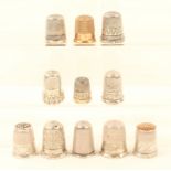 Eleven English thimbles, ten silver, one gold plated, including two with hardstone tops, one s.d.,