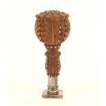 A fine French desk seal, the walnut or boxwood handle elaborately carved with leaves and decorated