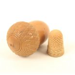 A vegetable ivory thimble case and thimble, the case of acorn form, the thimble with feather