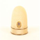 A Palais Royal thimble, in mother-of-pearl with gilt metal and enamel pansy motif above a plain