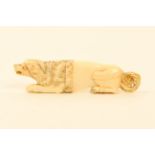 A fine Palais Royal carved ivory needlecase, in the form of a crouching dog, the tail pierced, the