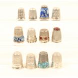 Twelve silver and white metal thimbles, including three continental examples with enamelled