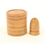 A line painted Tunbridge ware thimble, contained in an adapted line painted turned box, lid split,