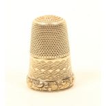 A 19th century gold thimble, the zig zag engraved frieze divided by a rectangular vacant cartouche