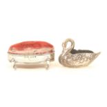 Two silver pincushions, comprising; an example modelled as a swan, original marks indistinct and