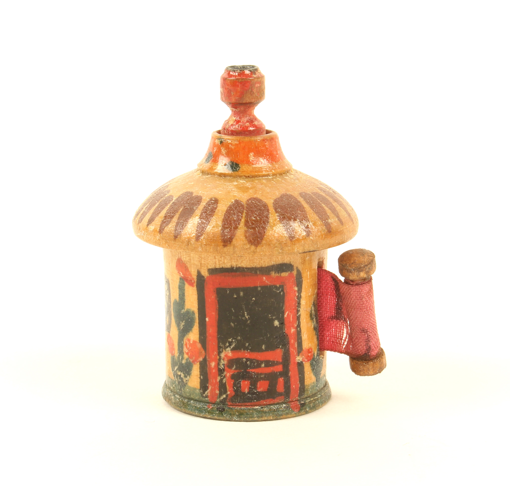 A painted Tunbridge ware cottage form tape measure, of cylinder form, painted with door, windows and