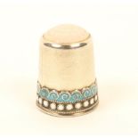 A Norwegian silver thimble, with enamelled 'waves and dot' border, below a moonstone top, marked