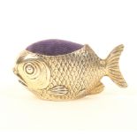 An Edwardian novelty silver gilt pincushion in the form of a fish, with blue velvet cushion, by