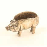 A silver pincushion in the form of a standing pig, marks virtually obliterated by polishing, 5cm