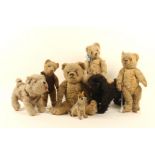 A group of well-loved and worn vintage soft toys, comprising; three dogs and four teddy bears,