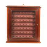 A 19th century mahogany wall mounting cabinet, enclosed by a hinged glazed door, the interior