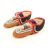 A pair of American Indian part beaded leather moccasins, probably Iroquois, late 19th/early 20th