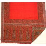 Two Kashmir shawls, one woven shawl on a red ground with deep boteh ends, signed to one corner,