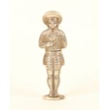 A continental figural silver needlecase, in the form of a man in Spanish costume, holding a bunch