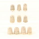 Ten English silver thimbles, most with decorative borders, all hallmarked. (10)