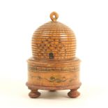 A painted Tunbridge ware skep form pincushion, the circular box base with leaf painted decoration