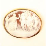 A large gold mounted cameo brooch, the shell carved with a group of three naked women with two