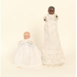 Two small bisque head dolls, comprising a black doll impressed 'A.M. Germany 341/6/1', jointed