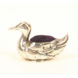 An Edwardian novelty silver pincushion in the form of a swimming duck, with upturned tail, by Sydney