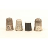 Four thimbles, comprising; a horn example with pearl top, and three early 19th century silver