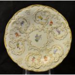 A Meissen circular Saucer Dish decorated with floral sprays and raised gilt scrolls, 9 1/2" (
