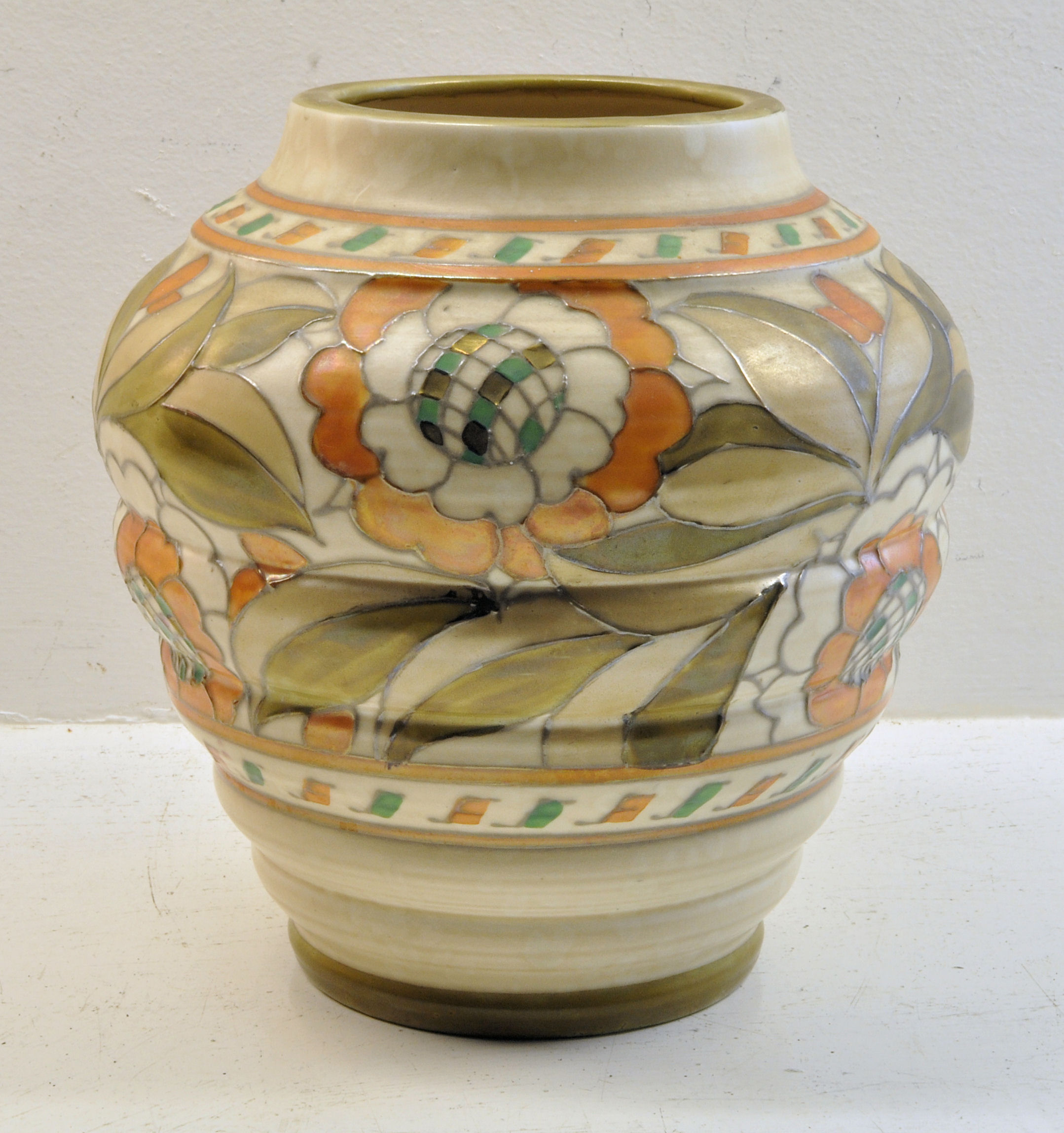 A Crown Ducal Vase by Charlotte Rhead, tube lined with flowers and leaves in orange, green, etc.,