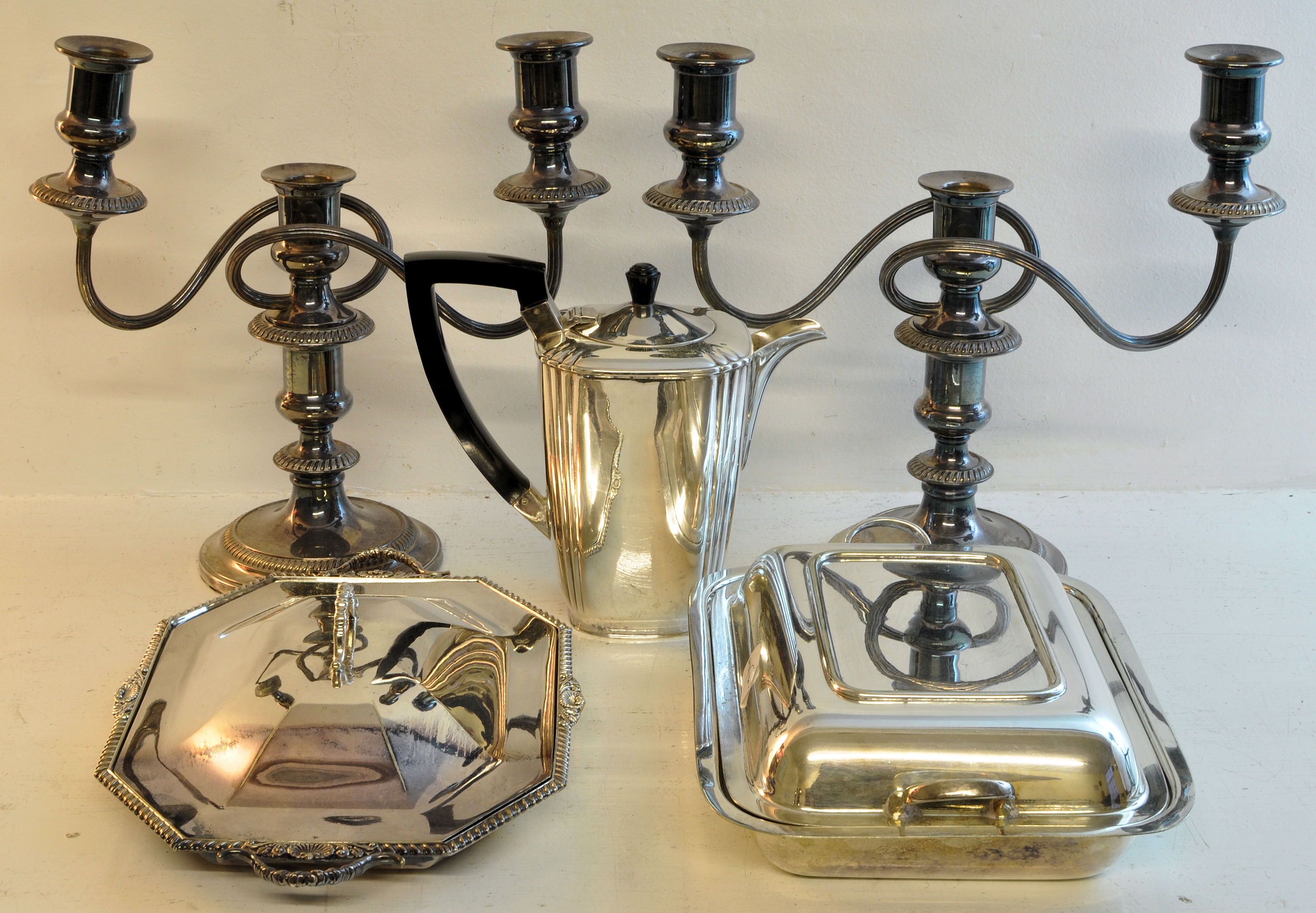 A pair of plated three light Candelabra on circular bases, two plated Entree Dishes and Covers,