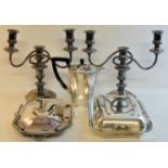 A pair of plated three light Candelabra on circular bases, two plated Entree Dishes and Covers,