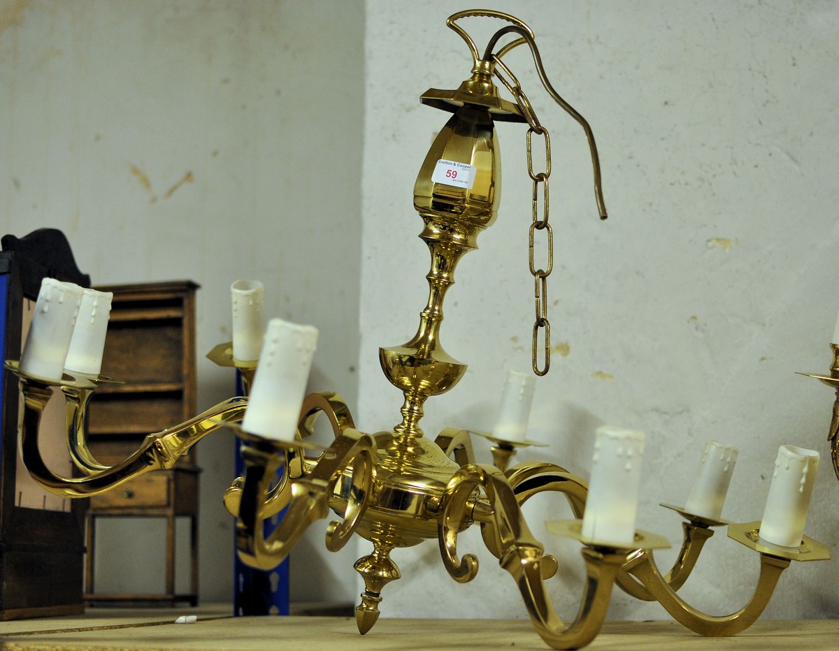 A brass eight light Electrolier with scroll branches and vase shape centre column.