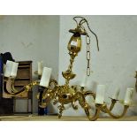A brass eight light Electrolier with scroll branches and vase shape centre column.