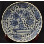 A Chinese provincial Saucer Dish decorated in blue and white with rock work, flowers, etc., 8" (