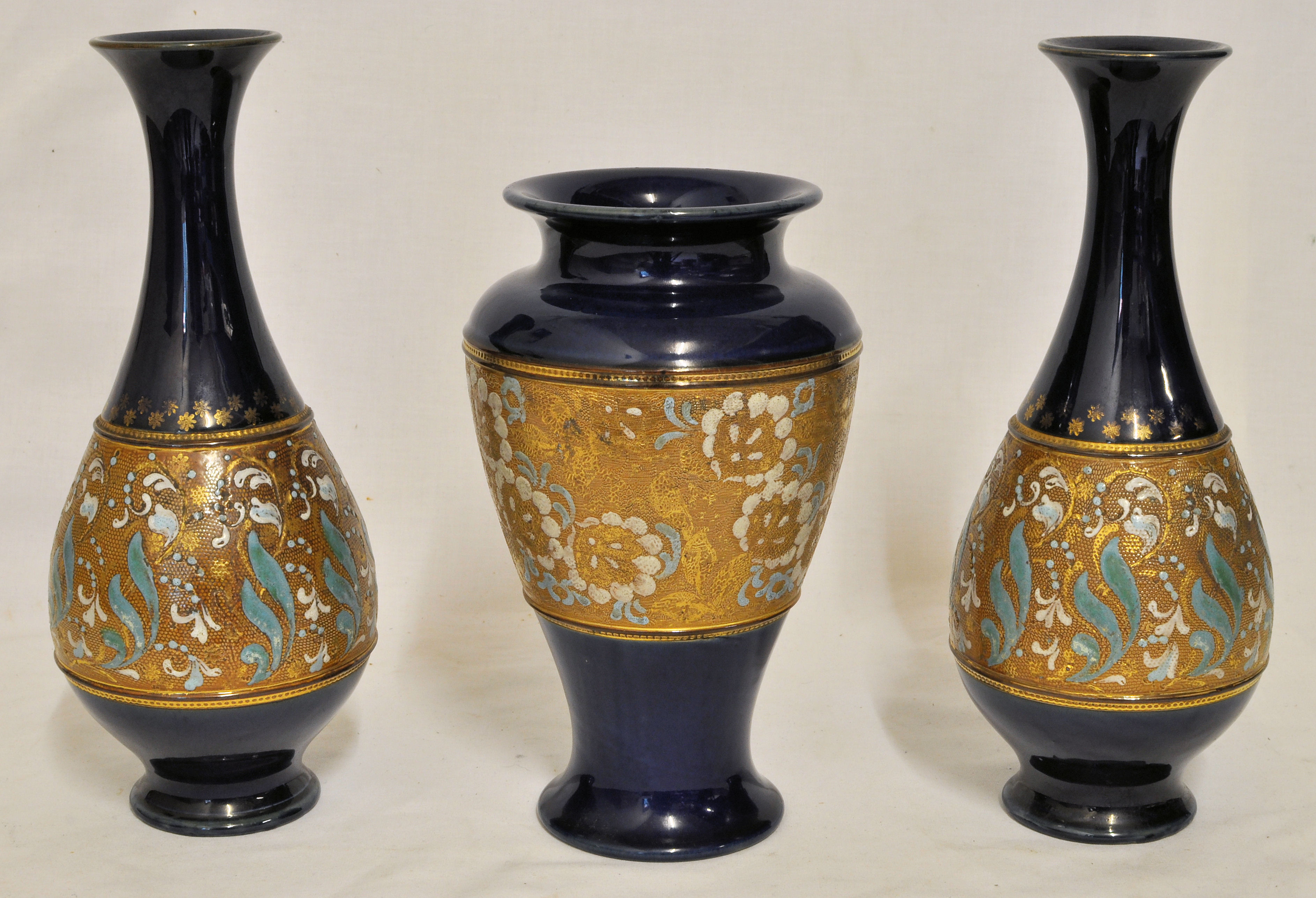 A pair of Royal Doulton Chine pattern baluster Vases on a dark blue ground, 10" (26cms) high.