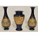 A pair of Royal Doulton Chine pattern baluster Vases on a dark blue ground, 10" (26cms) high.