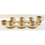 A Carter Stabler Adams Poole Pottery Coffee Set decorated with stylised flowers, comprising six cups