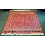 A Bokhara pattern Rug of traditional elephant's foot design on a red field and bordered, 6' 3" (