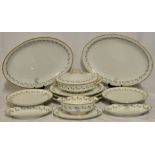 A quantity of Haviland Limoges Tableware with a leaf pattern moulded border, with oval serving