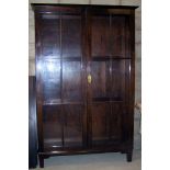 A mahogany Bookcase fitted with adjustable shelving and enclosed by a pair of glazed tracery