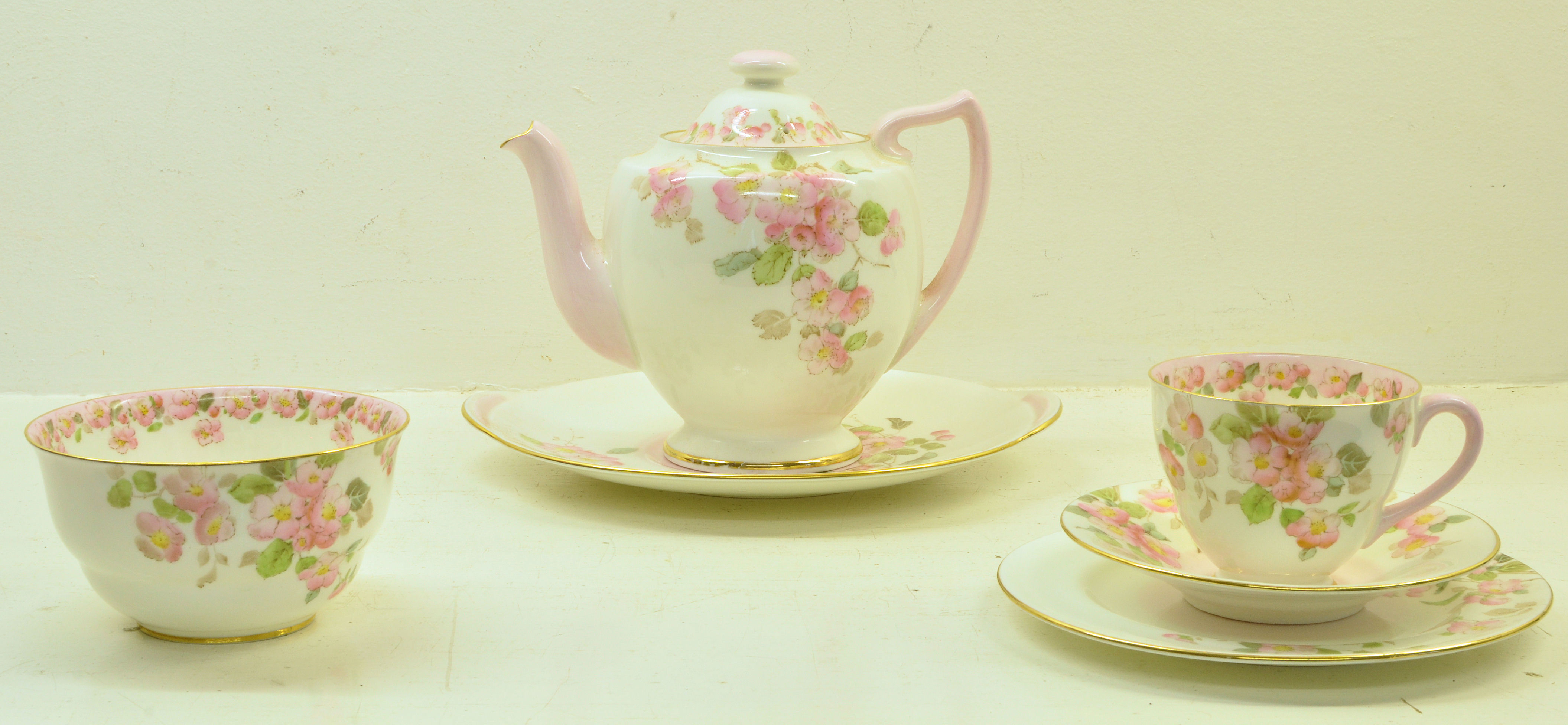 A Royal Doulton Sheila pattern Teaset decorated with floral sprays, comprising 12 cups and